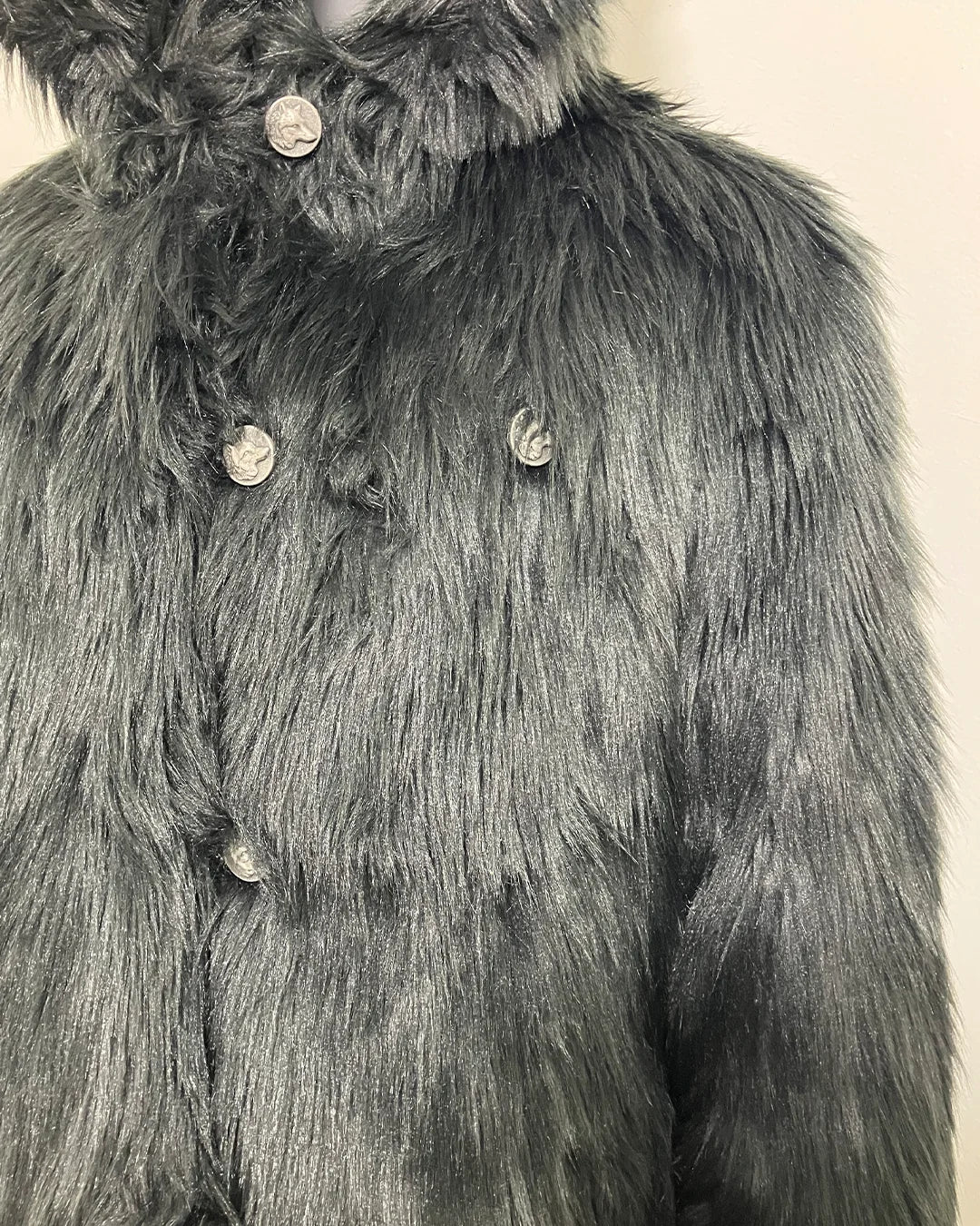 Close-up photo of the missing 2nd row of buttons on the SpiritHoods Online Sample Sale Hooded Black Faux Fur Coat - Black Wolf in size MEDIUM 