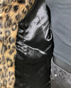 close-up photo of the poly-satin black lining and secret zipper pocket on the inner lining of the fake fur jacket