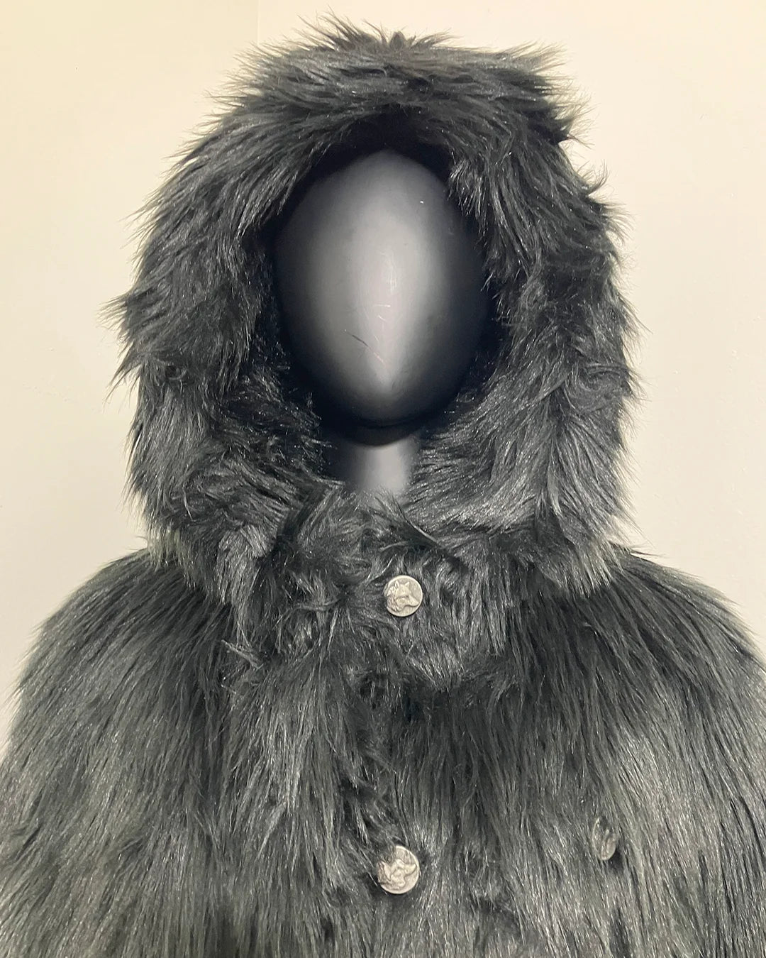 mannequin wearing a buttoned up black faux fur coat with oversized hood showcasing the wolf face buttons on the SpiritHoods Online Sample Sale Hooded Black Faux Fur Coat - Black Wolf in size MEDIUM 