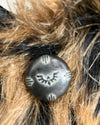 Close-up of spirithoods original logo button on the leopard classic faux fur coat
