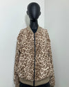 photo of a mannequin wearing the tan leopard print bomber jacket featuring a short pile beige and brown leopard print on a zipper bomber jacket with faux fur.