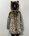 Leopard print coat with feline ears on a mannequin against a white background