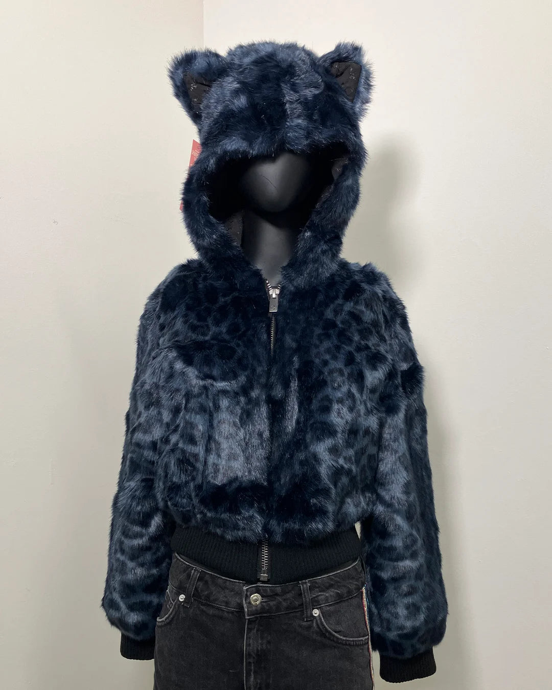 Blue leopard print faux fur cropped jacket with a hood on a mannequin against a white background