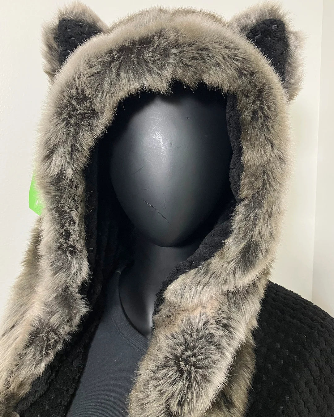 photo of a mannequin wearing the grey wolf luxe robe with the hood up showing the distinct ears and plush faux fur on the hood going down the front trim of the robe