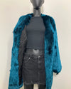 Mannequin wearing a teal faux fur coat over a gray top and skirt on a plain background | SpiritHoods Online Sample Sale Style: Luxury V-Neck Plush Faux Fur Coat in Royal Wolf in Size MEDIUM