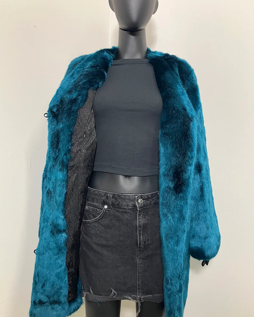 Mannequin wearing a teal faux fur coat over a gray top and skirt on a plain background | SpiritHoods Online Sample Sale Style: Luxury V-Neck Plush Faux Fur Coat in Royal Wolf in Size MEDIUM