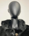 Black fur coat with a mannequin wearing it on a white background
