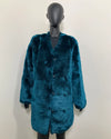 Teal faux fur coat on a mannequin against a white background, show casing the peacoat button closure and front wolf buttons.