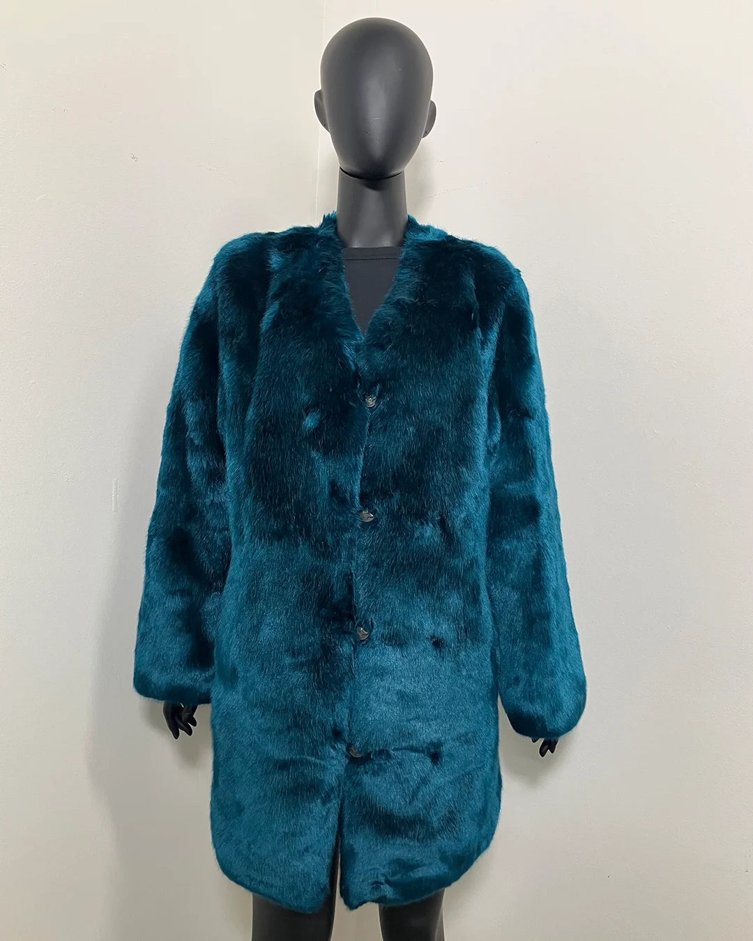 Teal faux fur coat on a mannequin against a white background, show casing the peacoat button closure and front wolf buttons.