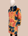 Multicolored fake fur coat on a mannequin against a beige background