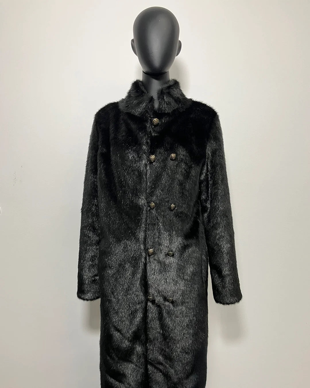 Black fake fur coat with fur collar on a mannequin against a white background
