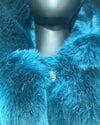 Close-up phot of the blue faux fur and wolf face button