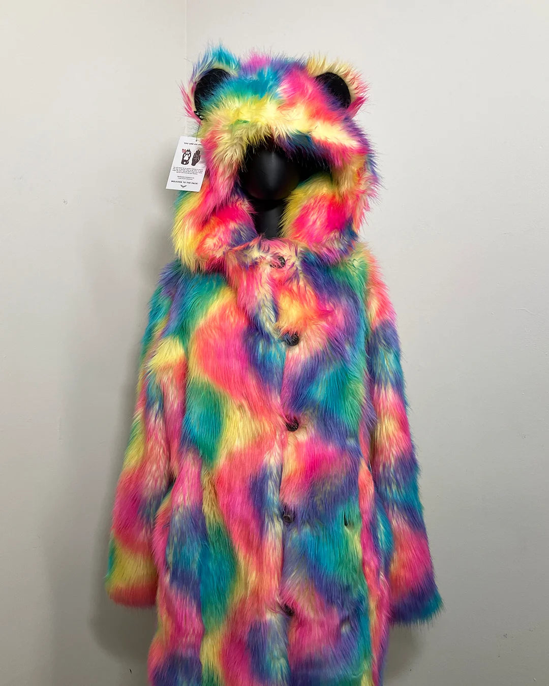 Multicolored fake fur coat with bear ears on a white background