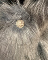 Close-up of a wolf face button on the Blue Wolf Faux Fur Luxe SpiritHoods Coat
