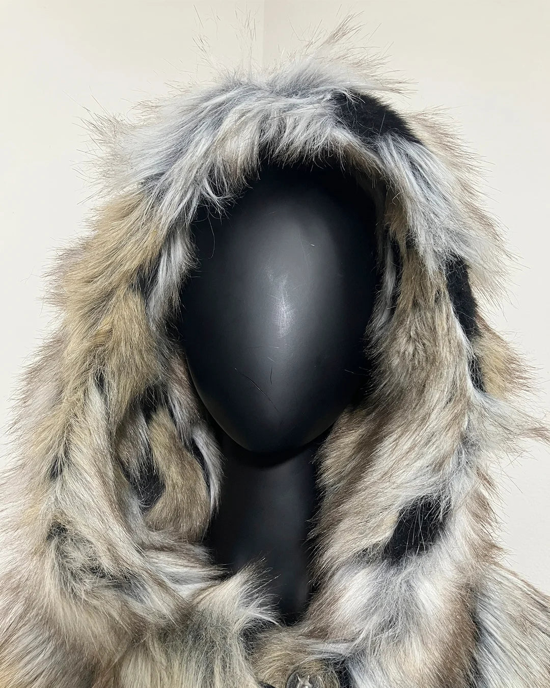 Close Up Photo of the Wolverine Faux Fur Coat Hood on a black mannequin against a white wall.