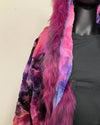 Mannequin wearing a colorful fur coat with a neutral background