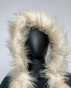 Mannequin wearing a coat with a fluffy white hood against a light gray background
