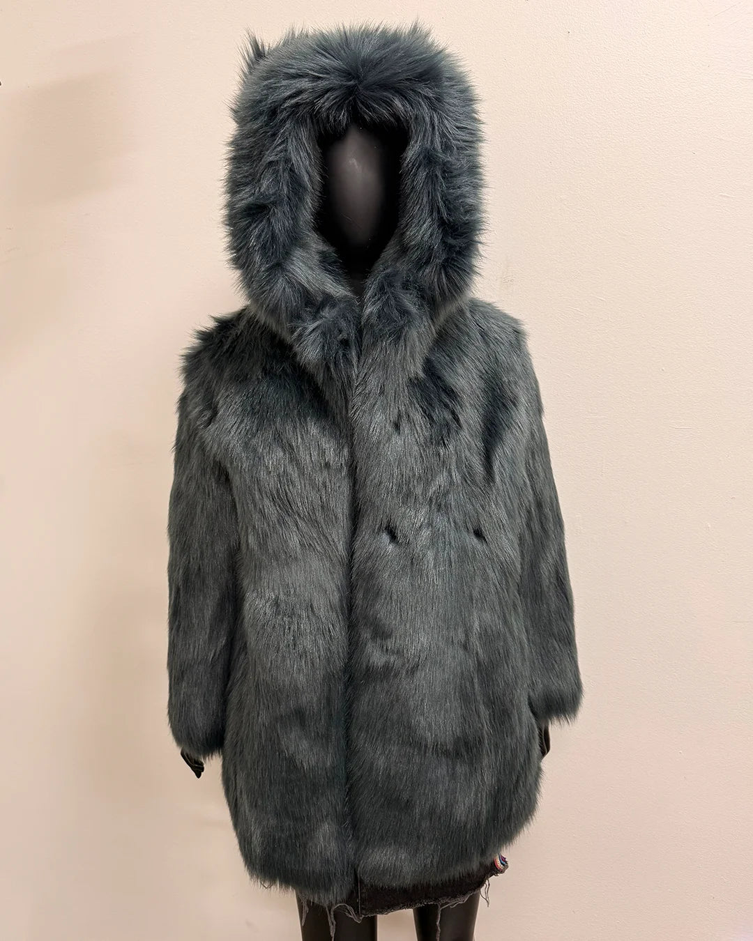 Gray/blue faux fur coat with hood on a beige background