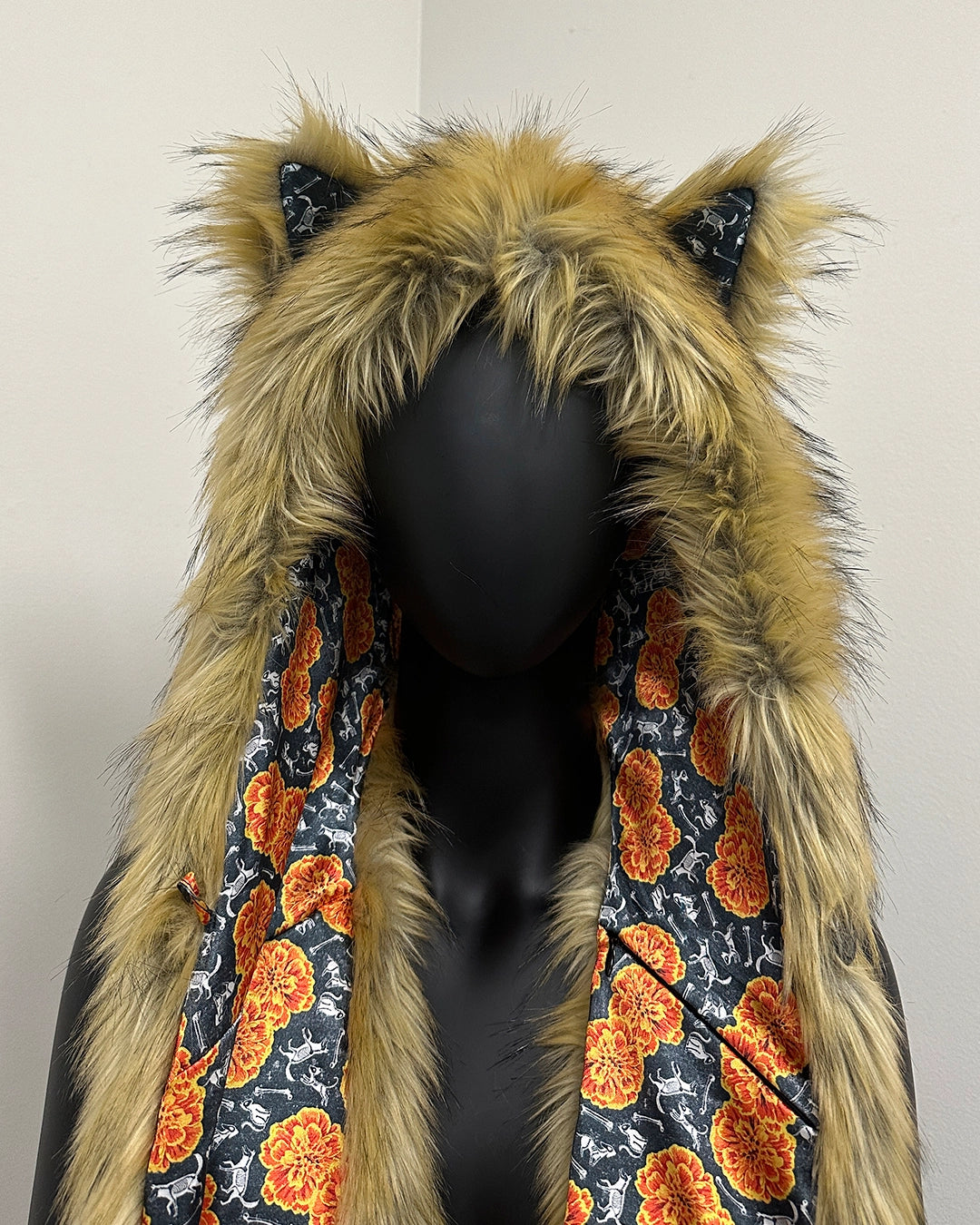Mannequin wearing a coat with a fur-lined hood and cat ears