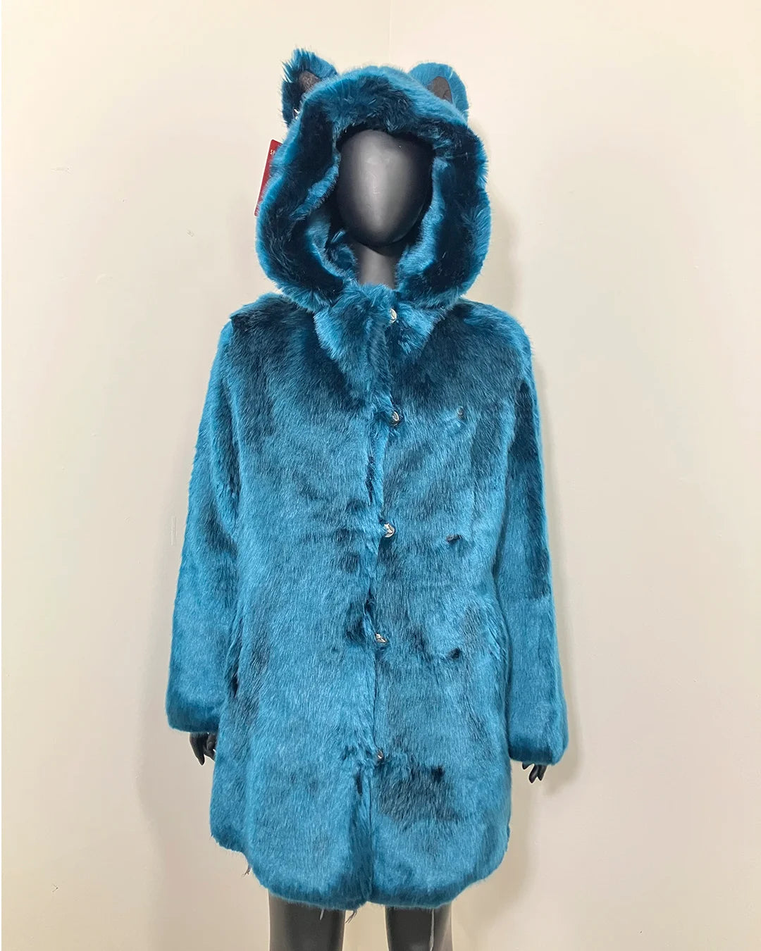 Royal Blue faux fur coat with wolf ears on a mannequin against a beige background