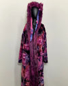 Multicolored robe with purple fake fur hood on a mannequin against a plain background