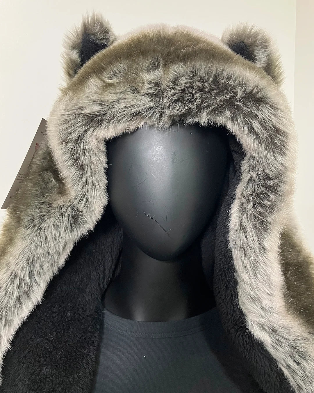 mannequin wearing a grey wolf faux fur spirithoods robe with black fabric body trimmed with a grey short pile fake fur