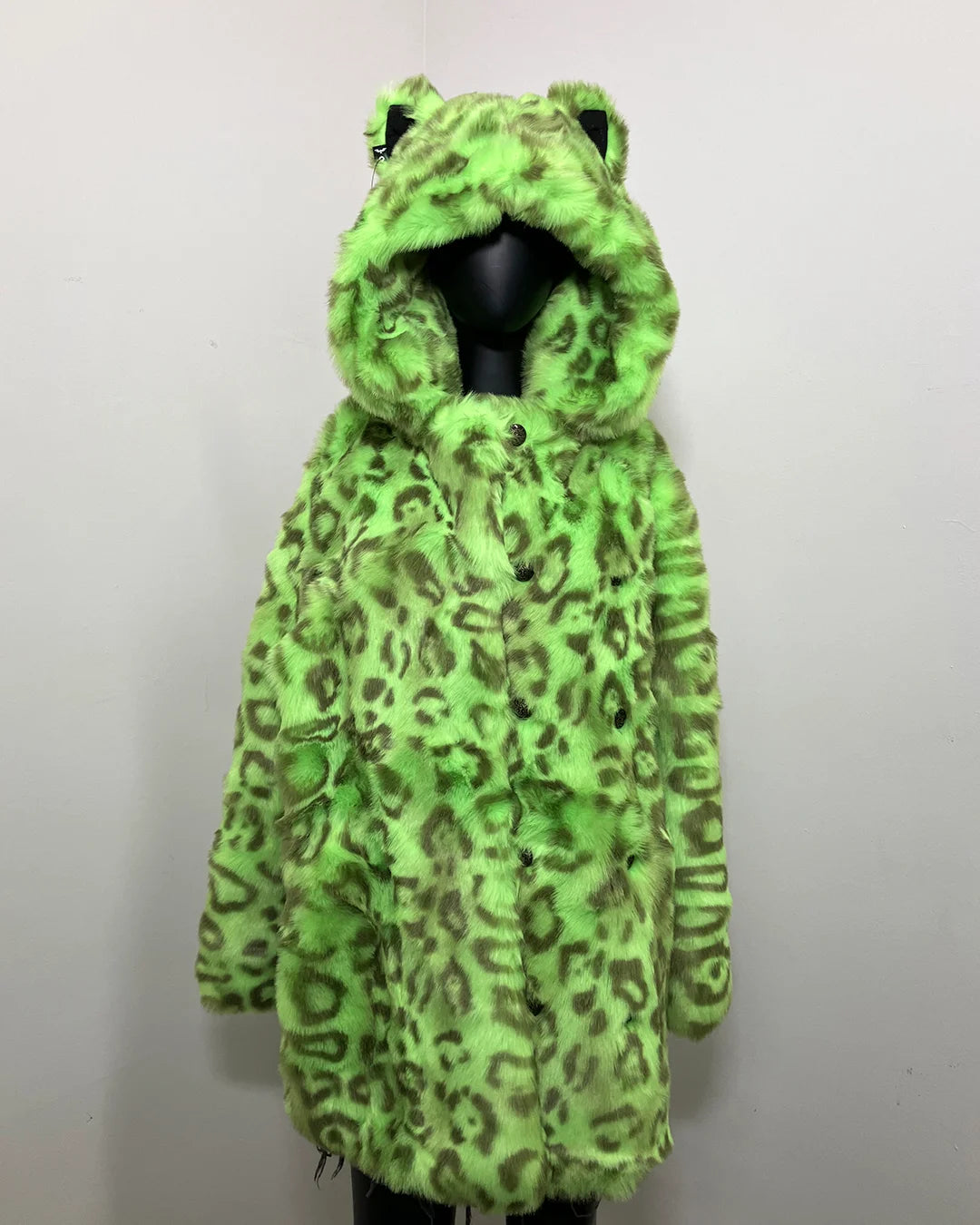 Green leopard fake fur coat  with an oversized hood and leopard ears on a mannequin against a white background