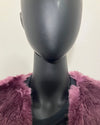 close up photo of the purple faux fur sewn into the seam new the neck line on both sides.