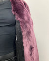 Close up photo of the light lavender purple faux fur and black snakeskin lining + inner welt pocket.