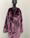 Purple faux fur coat on a mannequin against a white background