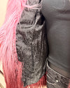 Close-up of a mannequin wearing a two-tone pink/maroon faux fur bomber jacket with a black faux snakeskin liner and inner zipper pocket