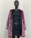 Mannequin wearing the purple lavender wolf faux fur v-neck coat in side MEDIUM with a black poly-rayon snakeskin lining