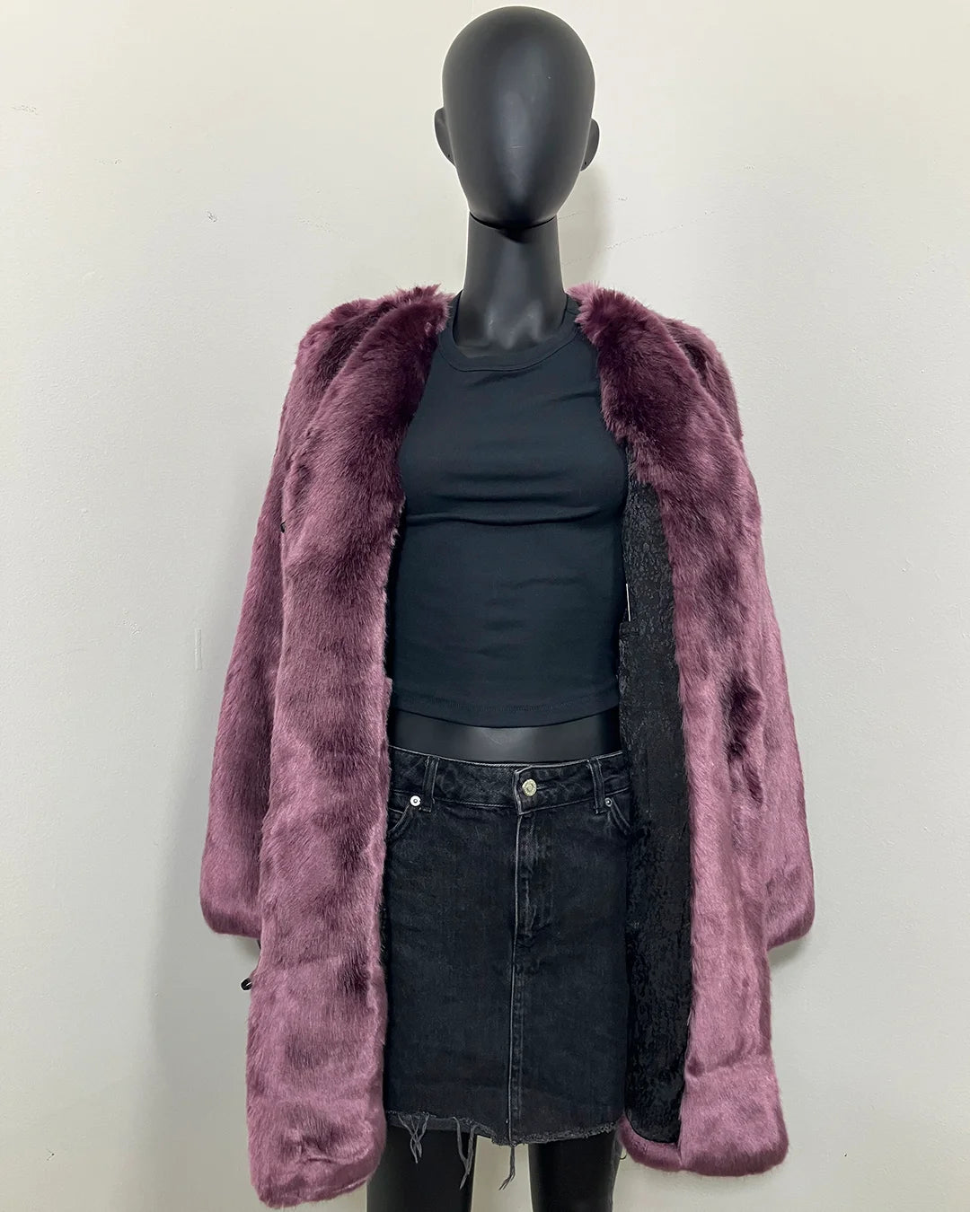 Mannequin wearing the purple lavender wolf faux fur v-neck coat in side MEDIUM with a black poly-rayon snakeskin lining