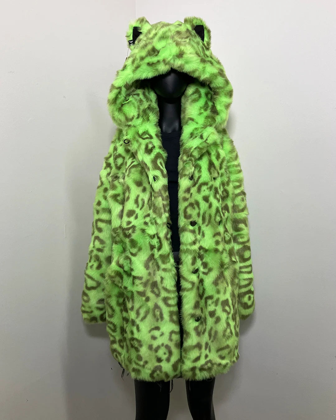 Green leopard print coat on a mannequin against a white background