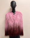 Mannequin wearing a pink and maroon ombre gradient faux fur coat against a beige background
