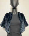 Blue leopard print shrug over a gray top on a mannequin against a beige background
