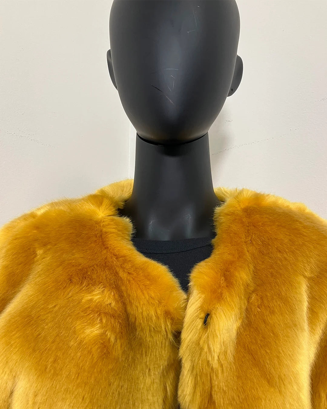 close-up photo of the neck/top of the SpiritHoods Online Sample Sale: one of a kind golden wolf faux fur bomber in luxe tissavel yellow fake fur in size MEDIUM.