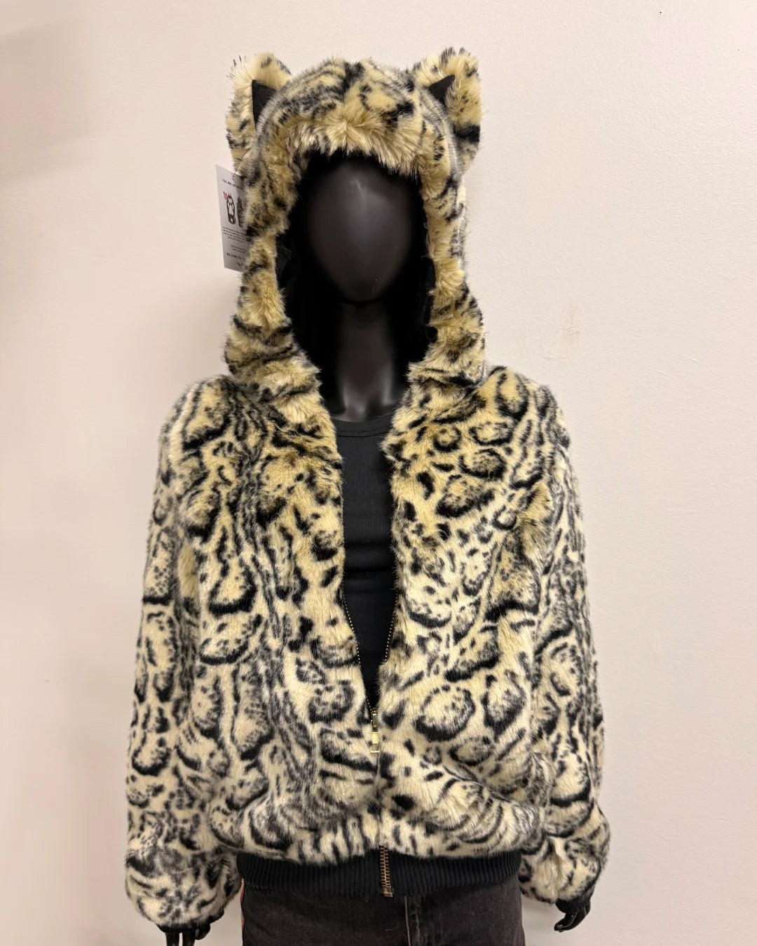 Leopard print bomber jacket with a hood and ears on a mannequin against a plain background