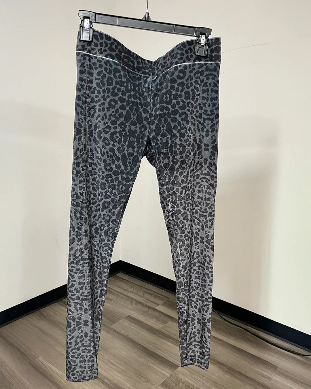 Gray leopard print velvet capri-style leggings on a black hnger.