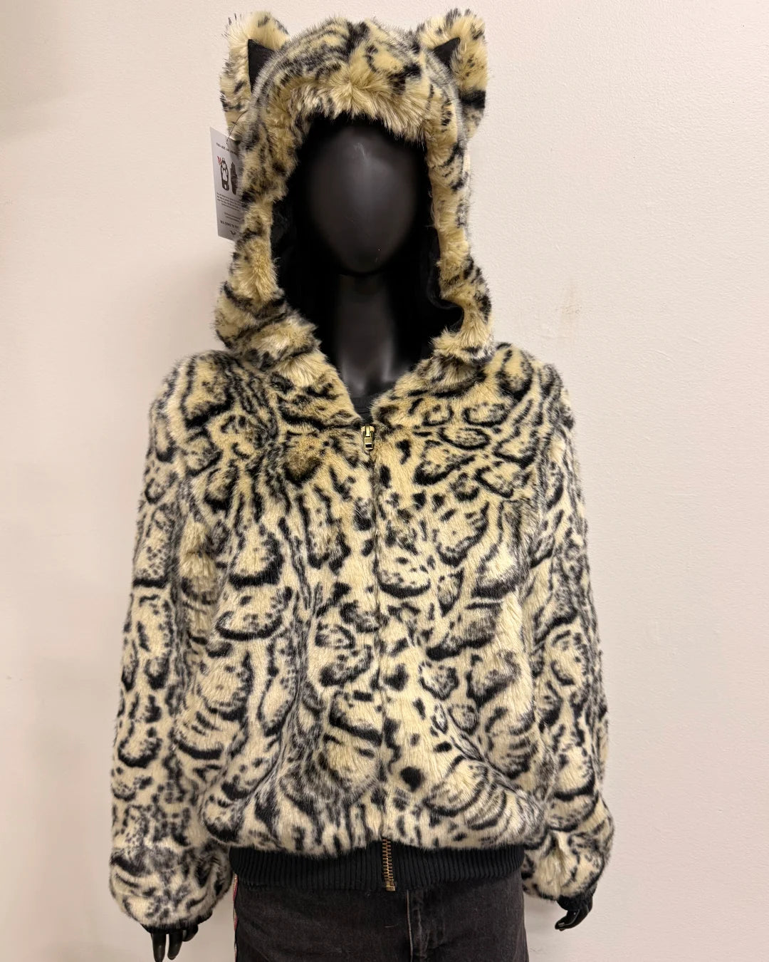 Leopard print bomber jacket with a hood and ears on a mannequin against a plain background