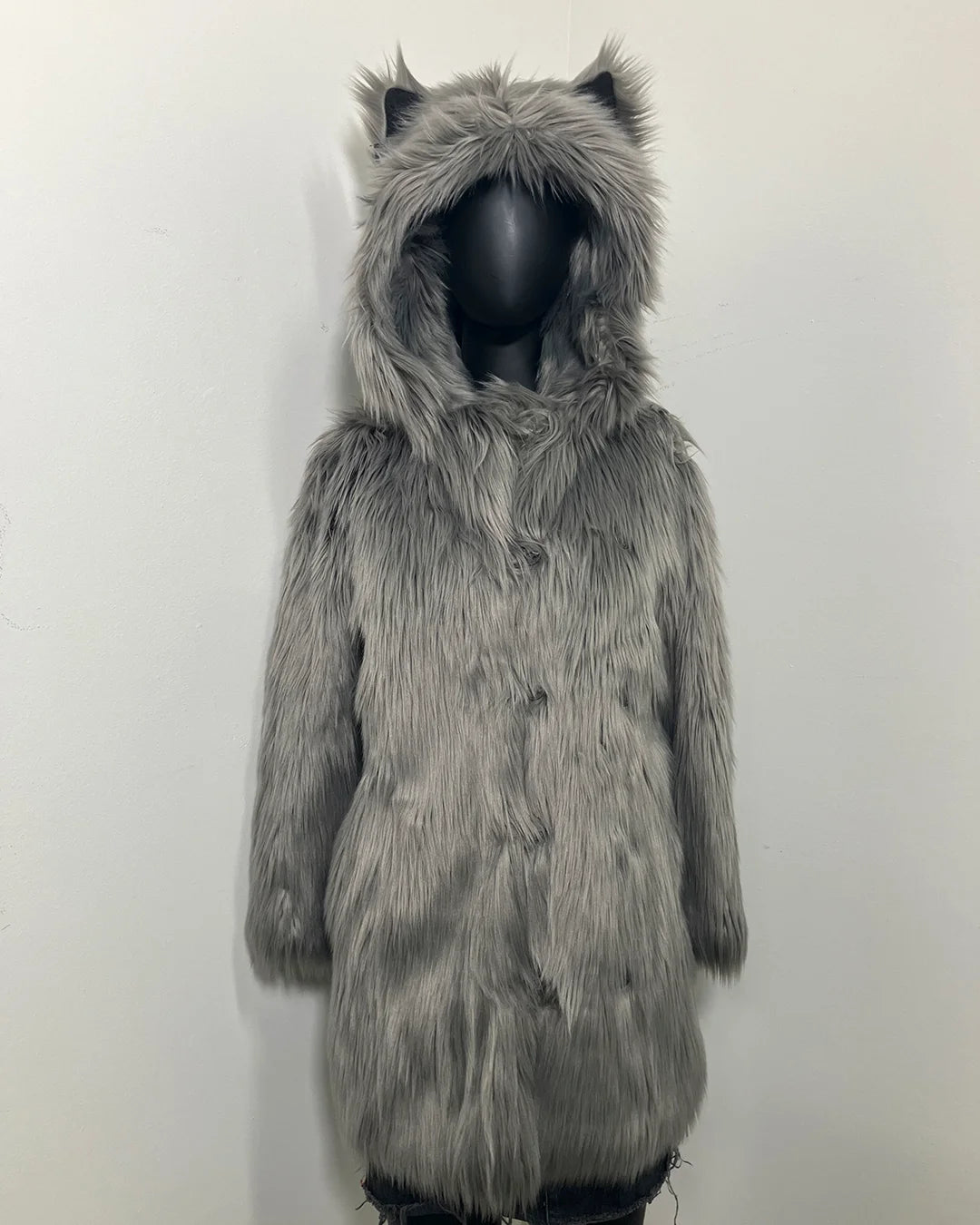 Gray furry coat with wolf ears on a mannequin against a white background