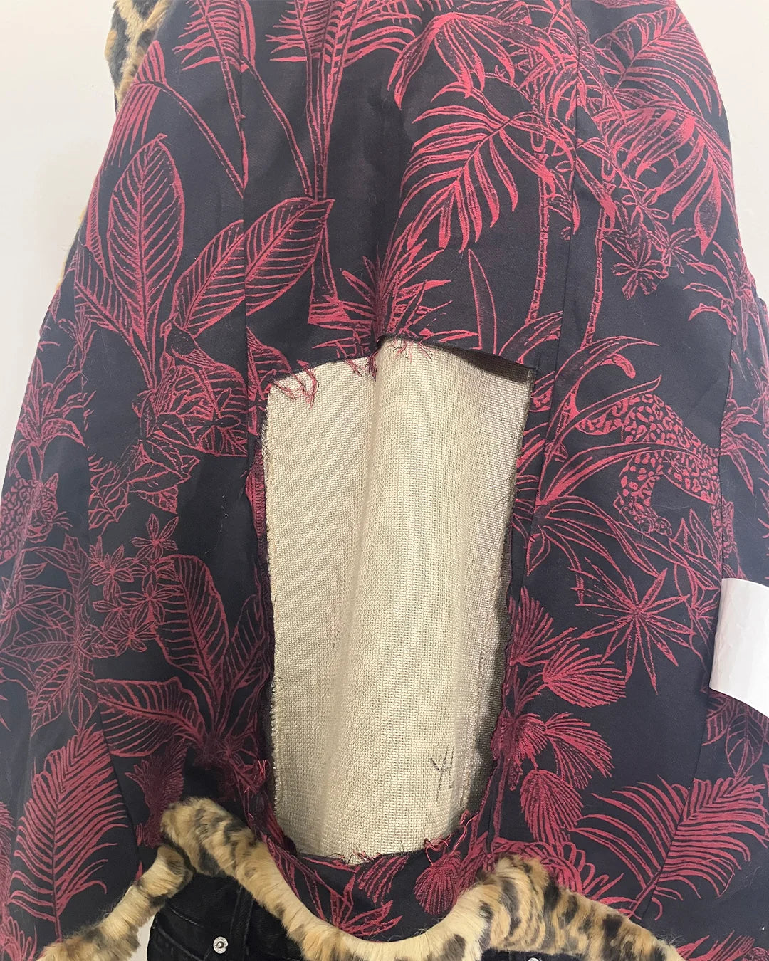 close-up photo of the damaged back panel of the lining, on the inner back part of the faux fur coat. SpiritHoods Online Sample Sale Style: Luxe Classic Faux Fur Coat in Jaguar Size X-SMALL.