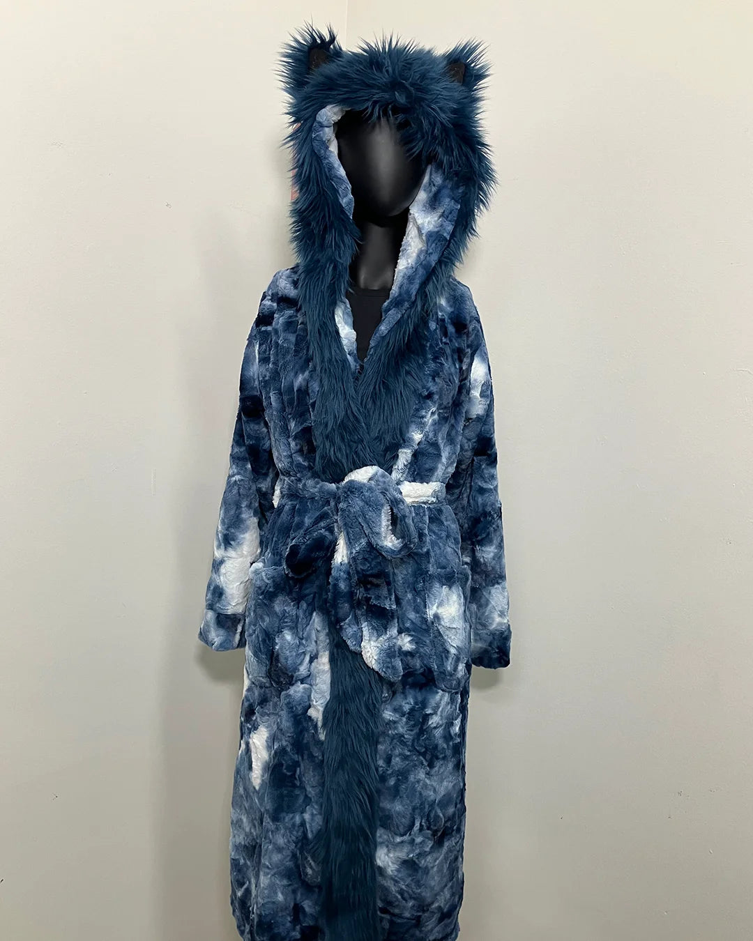 Blue tie-dye robe with a fake fur hood on a mannequin against a white background