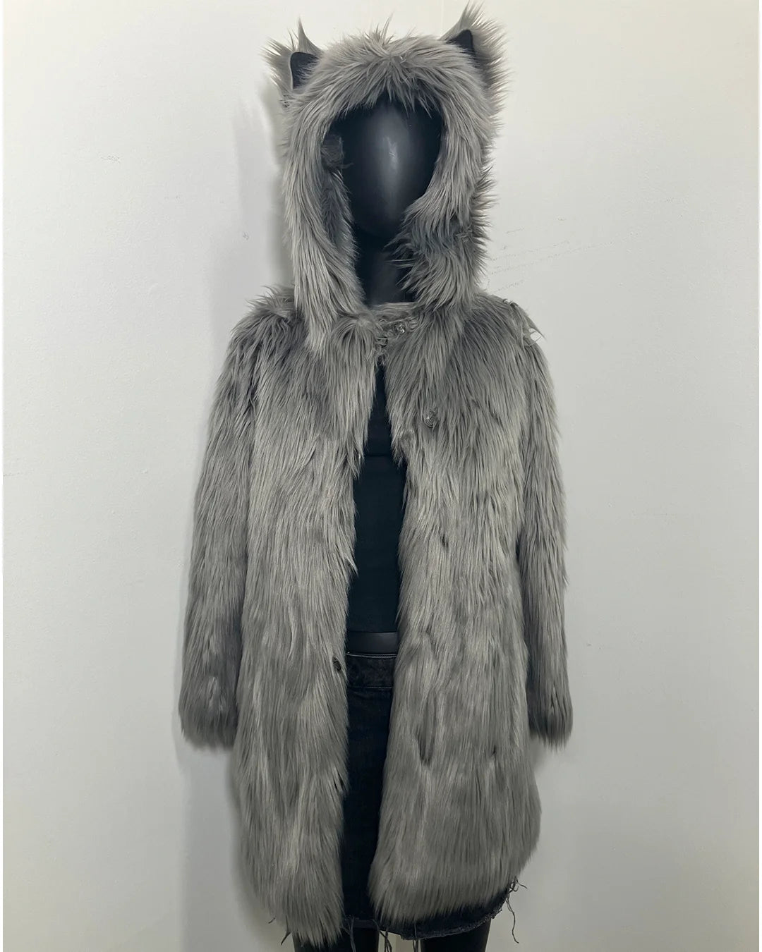 Gray faux fur coat with hood on a mannequin against a white background
