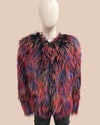 Multicolored shaggy fake fur bomber jacket on a mannequin against a beige background