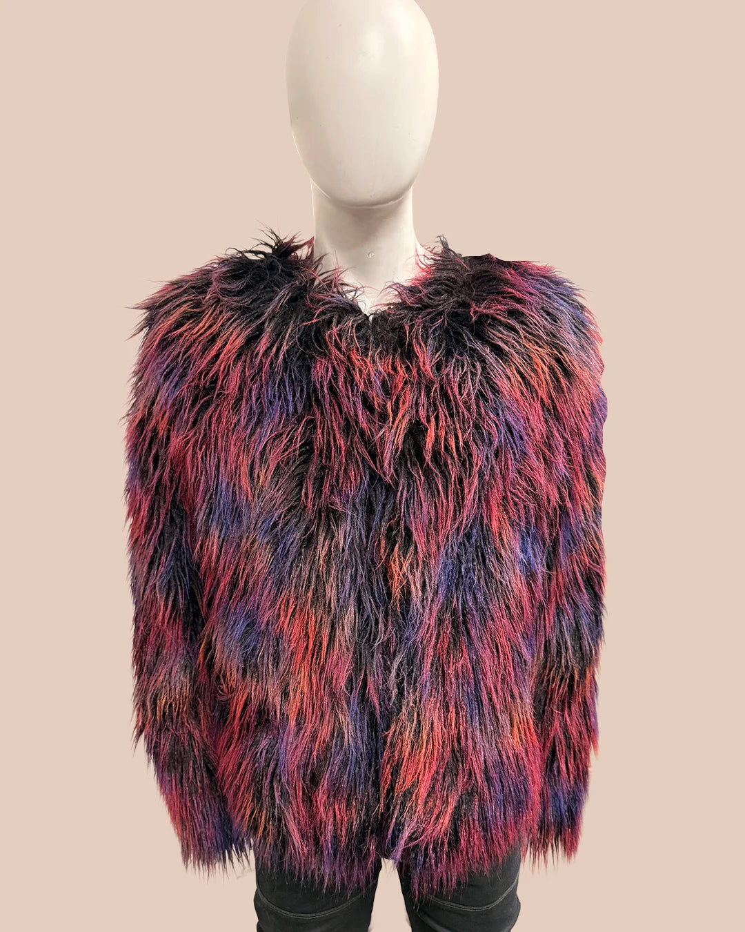 Multicolored shaggy fake fur bomber jacket on a mannequin against a beige background