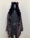 Mannequin wearing a dark purple faux fur coat with wolf ears on a white background