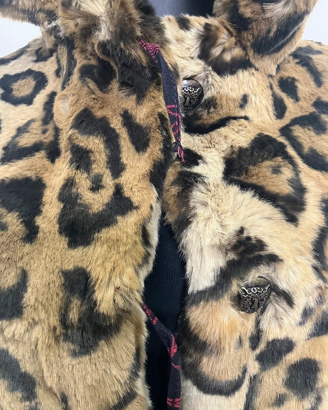 close-up photo of the two broken button loops on the front of the coat. SpiritHoods Online Sample Sale Style: Luxe Classic Faux Fur Coat in Jaguar Size X-SMALL.