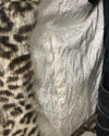 Close-up of a fake fur coat with a zipper pocket in the inner lining 