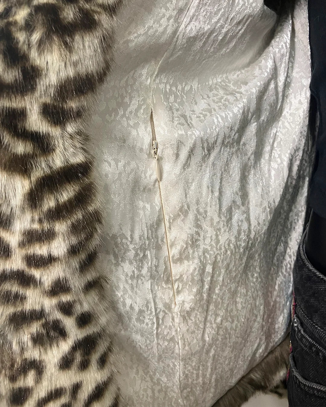 Close-up of a fake fur coat with a zipper pocket in the inner lining 